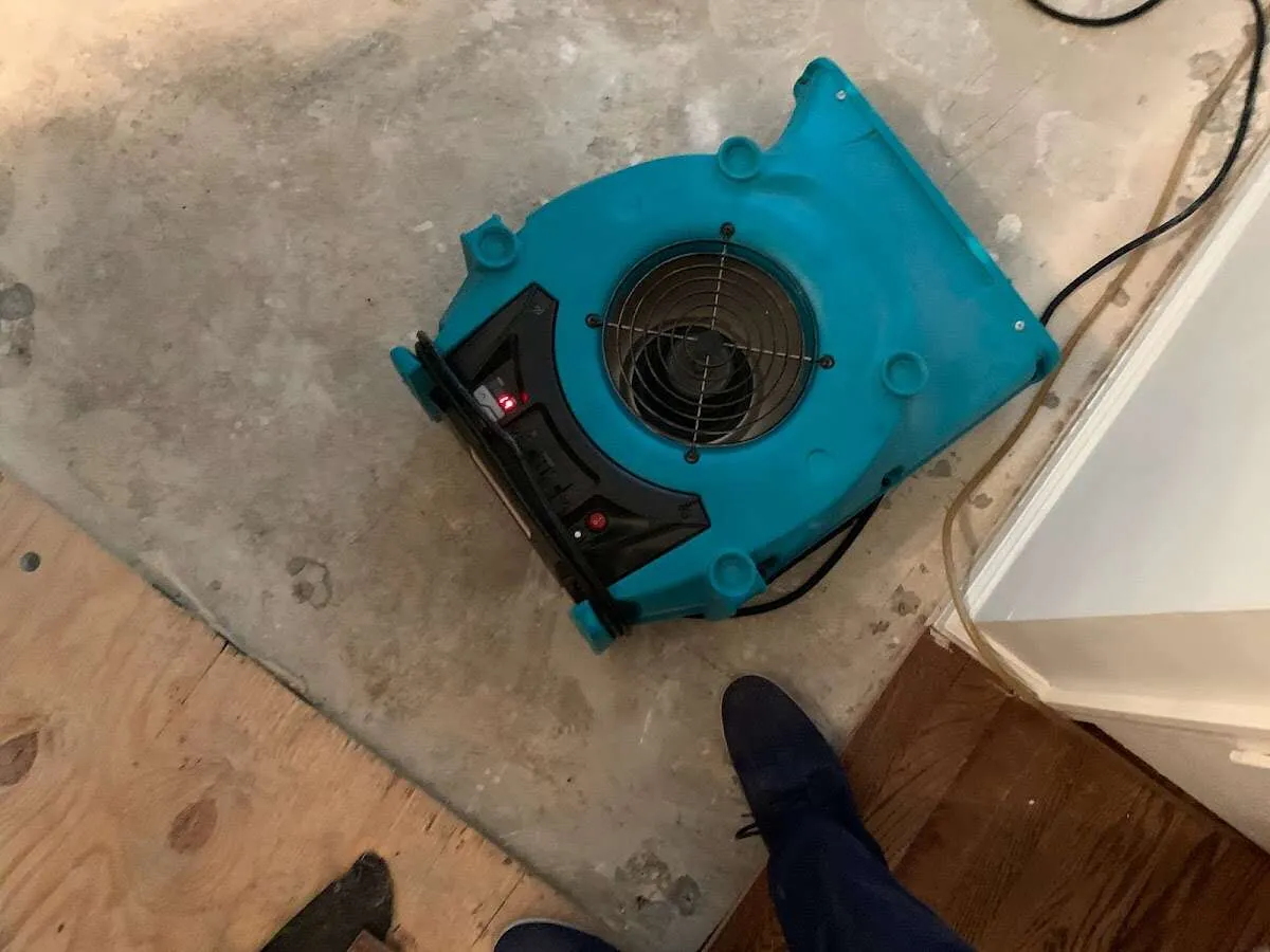 Air mover drying subfloor during Commercial Water Damage Restoration in Frisco